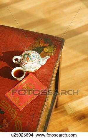 High angle view of a kettle and a cup with an envelope on the table View Large Photo Image Picture - High angle view of a kettle and a cup with an envelope on the table. Fotosearch