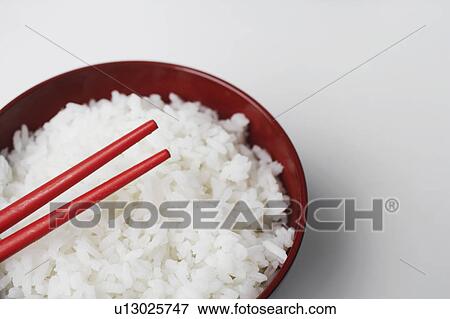 High angle view of a pair of chopsticks on a bowl of rice View Large Photo Image Stock Photo - High angle view of a pair of chopsticks on a bowl of rice. Fotosearch