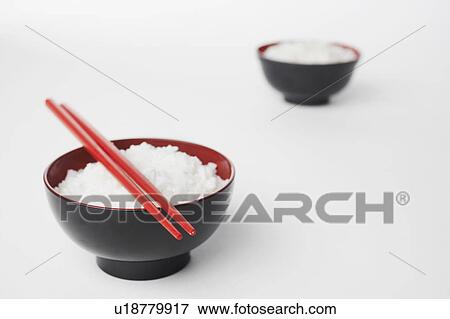 Stock Photo - High angle view of a pair of chopsticks on a bowl of rice. Fotosearch
