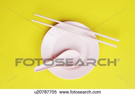 Stock Photography - High angle view of a plate and a spoon with chopsticks. Fotosearch