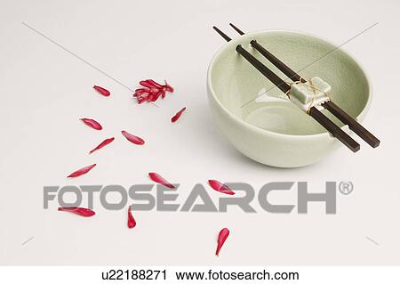 Stock Image - High angle view of chopsticks on a bowl. Fotosearch