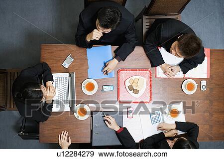 Stock Photo - High angle view of five business executives in a meeting. Fotosearch