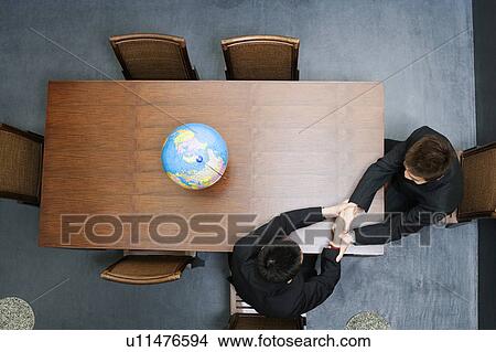 High angle view of two businessmen shaking hands View Large Photo Image Picture - High angle view of two businessmen shaking hands. Fotosearch