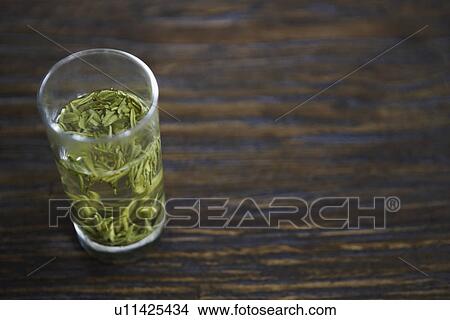 Leaves in a glass on the table View Large Photo Image Picture - Leaves in a glass on the table. Fotosearch