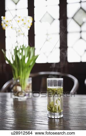Picture - Leaves in a glass on the table. Fotosearch