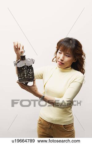 Stock Photo - Mature woman holding a lantern. Fotosearch