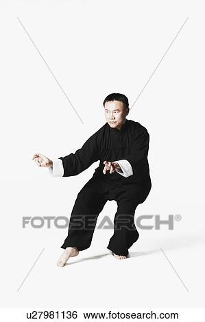 Mid adult man practicing martial arts View Large Photo Image Stock Photograph - Mid adult man practicing martial arts. Fotosearch