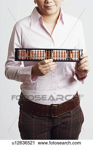 Mid section view of a businesswoman holding an abacus View Large Photo Image Stock Image - Mid section view of a businesswoman holding an abacus. Fotosearch