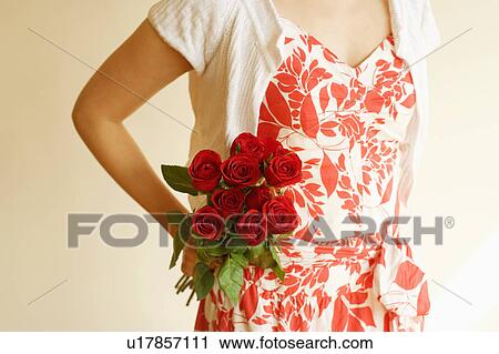 Mid section view of a woman holding a bunch of roses View Large Photo Image Stock Image - Mid section view of a woman holding a bunch of roses. Fotosearch