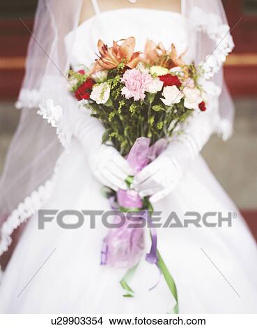 Picture - Mid section view of a young woman in the wedding dress. Fotosearch
