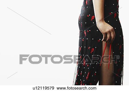 Mid section view of a young woman holding chopsticks View Large Photo Image Stock Photo - Mid section view of a young woman holding chopsticks. Fotosearch