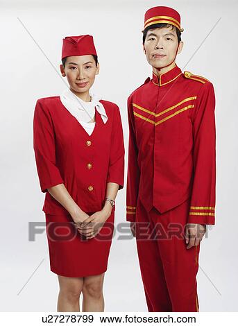 Stock Photo - Portrait of a bellhop and an air stewardess standing together and posing. Fotosearch