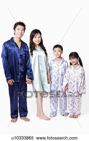 Stock Photography - Portrait of a boy and a girl standing with their parents. Fotosearch