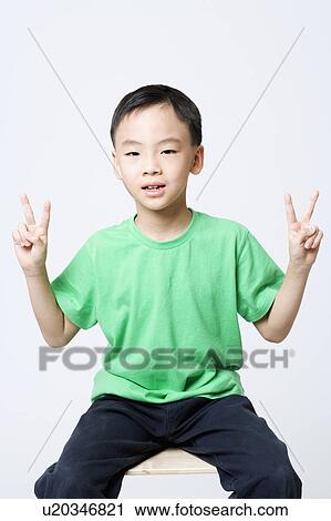 Portrait of a boy making a peace sign View Large Photo Image Stock Image - Portrait of a boy making a peace sign. Fotosearch