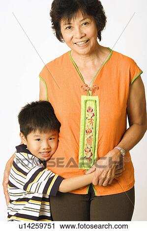 Portrait of a boy standing with his grandmother View Large Photo Image Stock Image - Portrait of a boy standing with his grandmother. Fotosearch