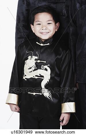 Portrait of a boy standing with his father smiling View Large Photo Image Stock Photo - Portrait of a boy standing with his father smiling. Fotosearch