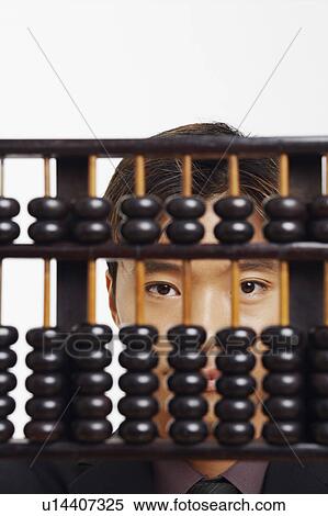 Portrait of a businessman behind an abacus View Large Photo Image Stock Photography - Portrait of a businessman behind an abacus. Fotosearch