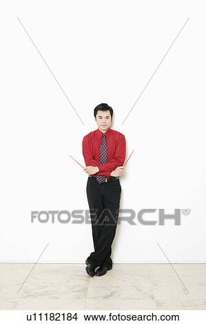 Picture - Portrait of a businessman holding chopsticks. Fotosearch