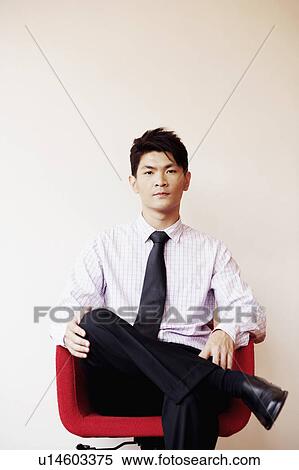 Stock Photography - Portrait of a businessman sitting in an armchair. Fotosearch