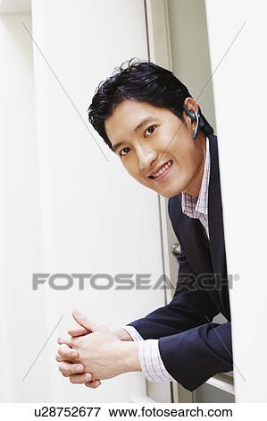 Portrait of a businessman smiling View Large Photo Image Stock Photo - Portrait of a businessman smiling. Fotosearch