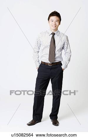 Portrait of a businessman smiling with his hands in his pockets View Large Photo Image Picture - Portrait of a businessman smiling with his hands in his pockets. Fotosearch