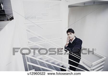 Portrait of a businessman talking on a mobile phone View Large Photo Image Stock Image - Portrait of a businessman talking on a mobile phone. Fotosearch