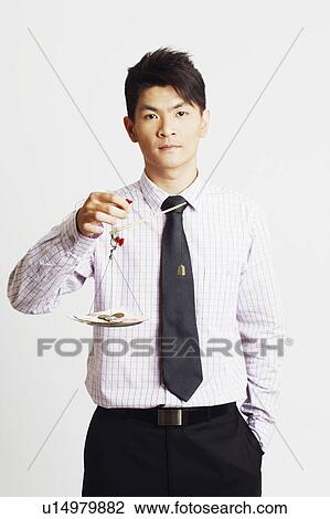 Portrait of a businessman weighing paper currency with coins on a weighing scale View Large Photo Image Stock Image - Portrait of a businessman weighing paper currency with coins on a weighing scale. Fotosearch