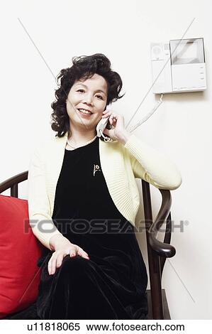 Portrait of a businesswoman talking on the telephone smiling View Large Photo Image Stock Photography - Portrait of a businesswoman talking on the telephone smiling. Fotosearch