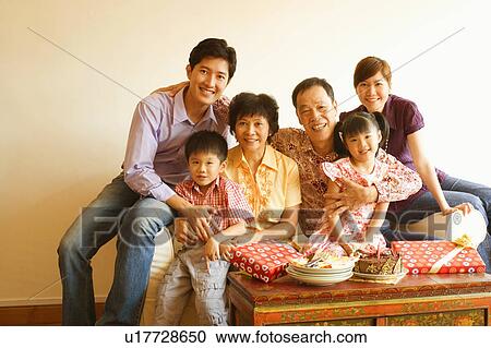 Stock Image - Portrait of a family celebrating a birthday party. Fotosearch
