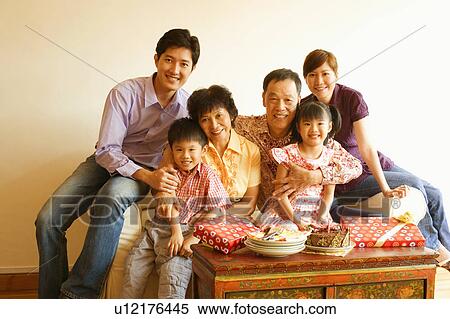Stock Photography - Portrait of a family celebrating a birthday party. Fotosearch