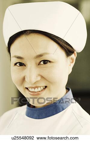 Stock Image - Portrait of a female nurse smiling. Fotosearch