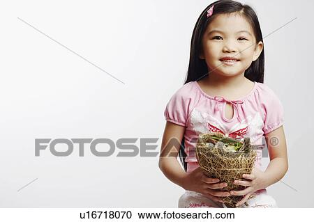 Portrait of a girl holding eggs in a bird's nest View Large Photo Image Stock Image - Portrait of a girl holding eggs in a bird's nest. Fotosearch