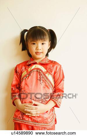 Stock Image - Portrait of a girl leaning against a wall. Fotosearch
