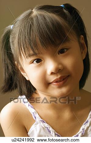 Stock Image - Portrait of a girl smiling. Fotosearch