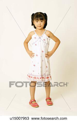 Portrait of a girl standing with arms akimbo View Large Photo Image Stock Image - Portrait of a girl standing with arms akimbo. Fotosearch