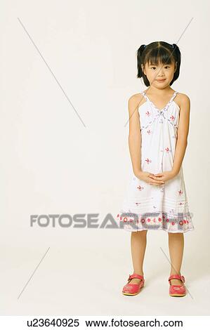 Portrait of a girl standing with her hands clasped View Large Photo Image Stock Photography - Portrait of a girl standing with her hands clasped. Fotosearch
