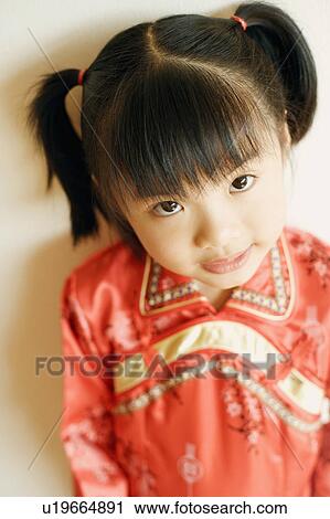 Stock Image - Portrait of a girl wearing traditional clothing. Fotosearch