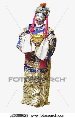 Stock Photo - Portrait of a male Chinese opera performer holding a bowl full of gold coins. Fotosearch
