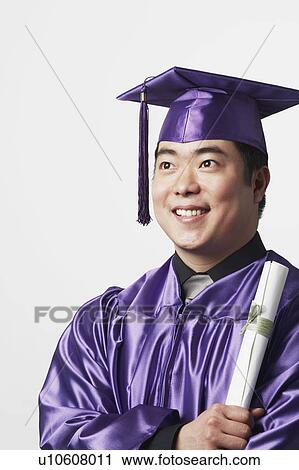 Portrait of a male graduate holding a diploma View Large Photo Image Stock Image - Portrait of a male graduate holding a diploma. Fotosearch