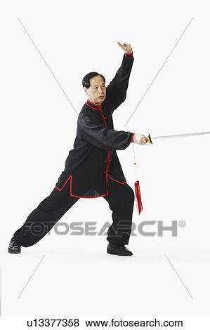 Stock Photo - Portrait of a mature man holding a sword. Fotosearch