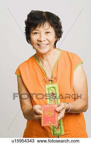 Portrait of a mature woman holding a greeting card View Large Photo Image Stock Image - Portrait of a mature woman holding a greeting card. Fotosearch