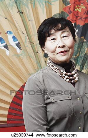 Portrait of a mature woman smiling View Large Photo Image Picture - Portrait of a mature woman smiling. Fotosearch