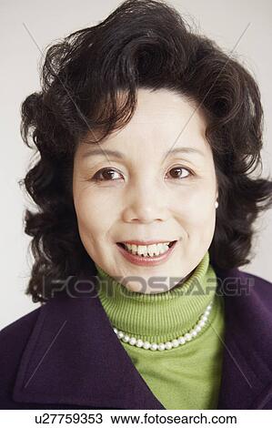 Portrait of a mature woman smiling View Large Photo Image Stock Image - Portrait of a mature woman smiling. Fotosearch