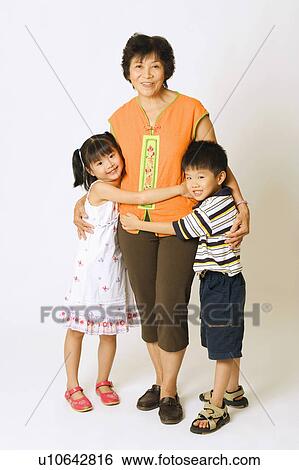 Portrait of a mature woman standing with her grandson and a granddaughter View Large Photo Image Stock Photograph - Portrait of a mature woman standing with her grandson and a granddaughter. Fotosearch