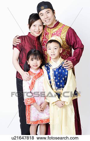 Portrait of a mid adult man and a young woman standing with their children View Large Photo Image Stock Photo - Portrait of a mid adult man and a young woman standing with their children. Fotosearch