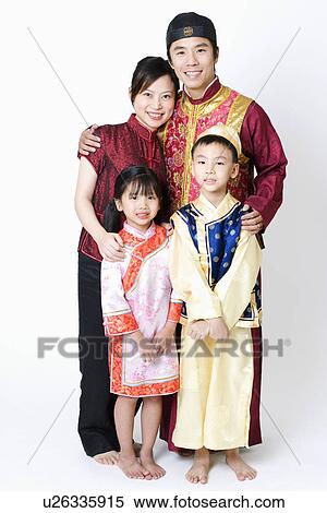 Stock Photography - Portrait of a mid adult man and a young woman standing with their children. Fotosearch
