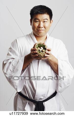 Portrait of a mid adult man holding a bird's nest View Large Photo Image Stock Photo - Portrait of a mid adult man holding a bird's nest. Fotosearch