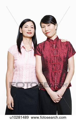 Portrait of a mid adult woman and young woman standing side by side View Large Photo Image Stock Photo - Portrait of a mid adult woman and young woman standing side by side. Fotosearch