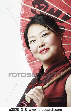 Portrait of a mid adult woman holding a parasol View Large Photo Image Stock Photo - Portrait of a mid adult woman holding a parasol. Fotosearch
