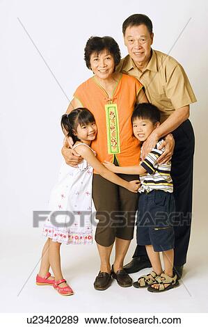 Portrait of a senior man and a mature woman standing with their grandchildren View Large Photo Image Stock Photo - Portrait of a senior man and a mature woman standing with their grandchildren. Fotosearch
